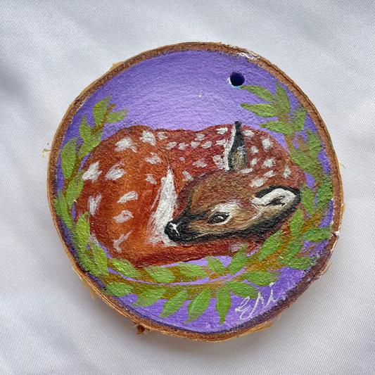 Fawn Sleeping On Wood Slice